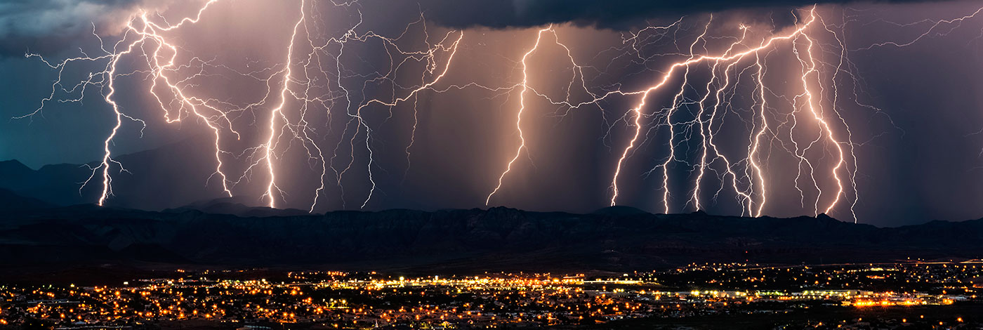 Photo of lightning striking near a suburban neighborhood.
